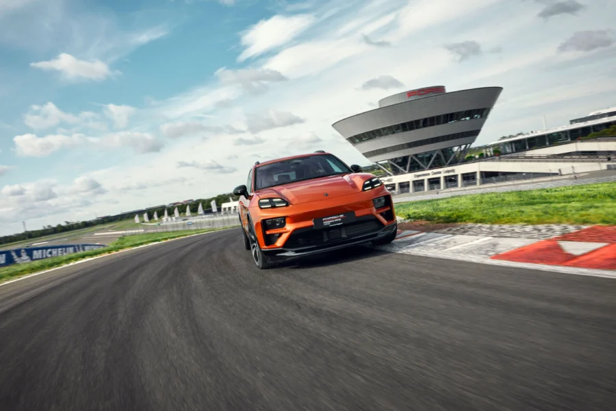 Ein Porsche-Fahrzeug wird auf einer Rennstrecke im Experience Center gefahren. Das Bild zeigt das dynamische Erlebnis und die Performance des Porsche auf der Strecke.